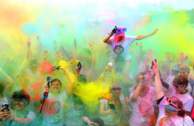 photo of colour run participants in a cloud of coloured powder