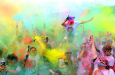 photo of colour run participants in a cloud of coloured powder