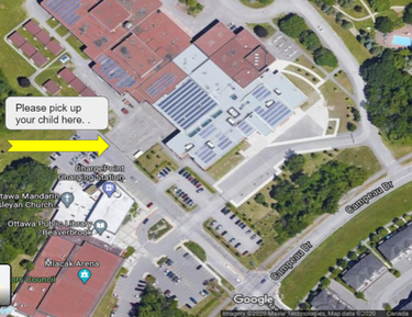 view of the school from above indicating student pick up area with a yellow arrow