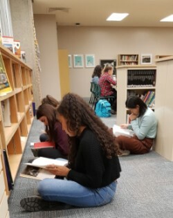 students sitting on the floor reading